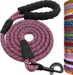 Pink and black braided rope leash with black handle and clip, surrounded by a stack of colorful ropes.