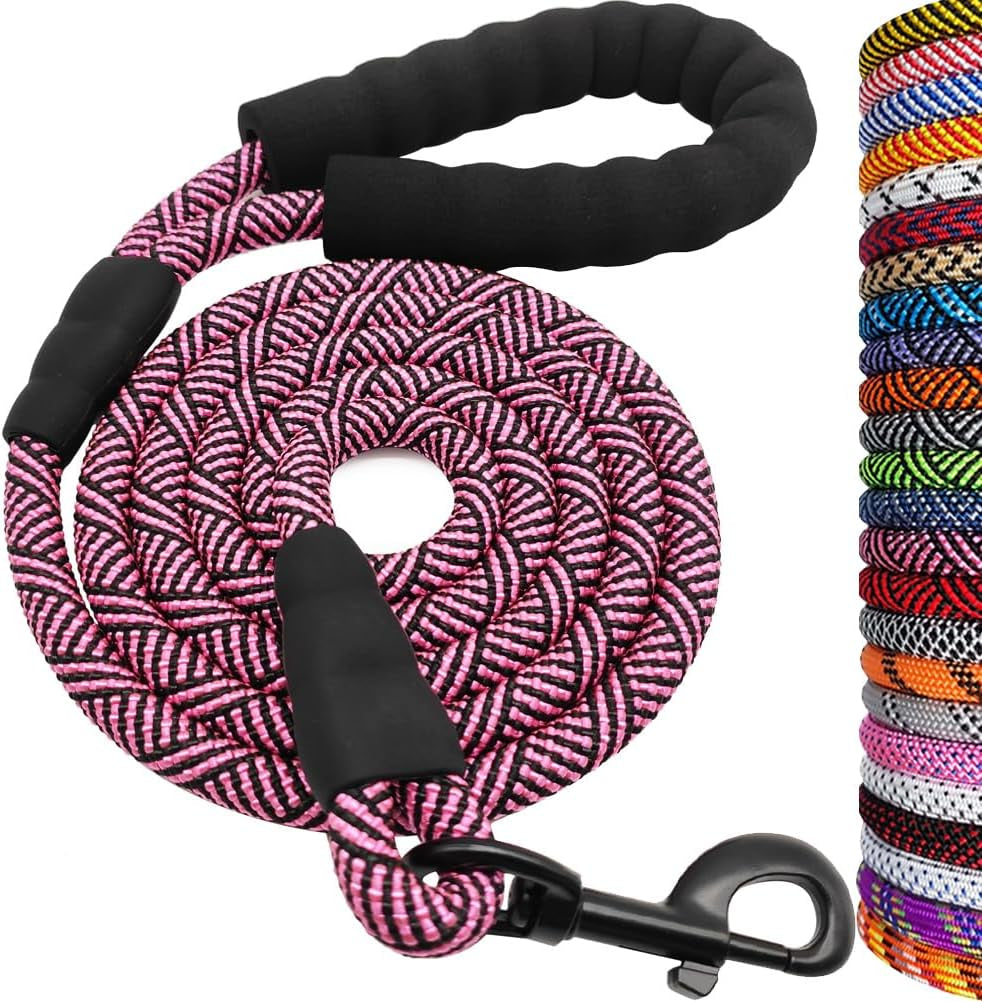 Pink and black braided rope leash with black handle and clip, surrounded by a stack of colorful ropes.
