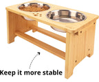 Wooden pet feeding station with two stainless steel bowls on a white background