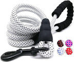 White dog leash with black pattern and black handle on a white background